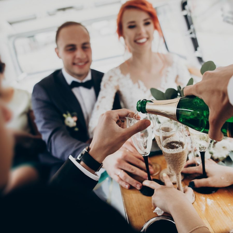 stylish-happy-bride-and-groom-toasting-with-glasses-of-champagne-and-having-fun.jpg